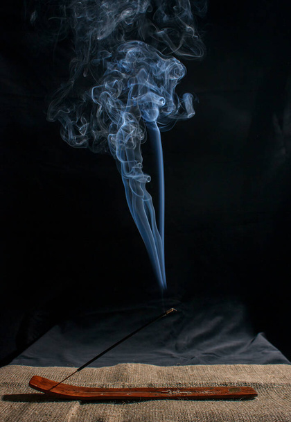 indian incense stick with smoke on black background indoor closeup - Photo, Image