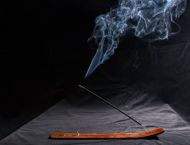 indian incense stick with smoke on black background indoor closeup - Photo, Image