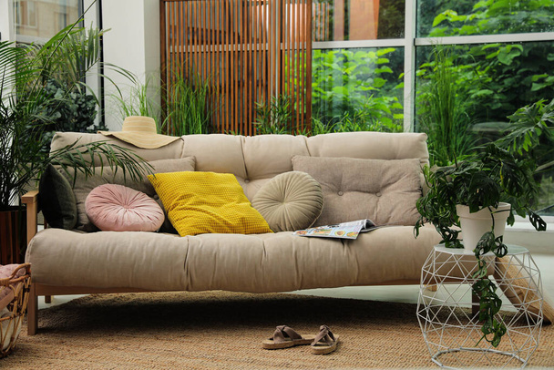 Interior terraço interior com sofá confortável e plantas verdes - Foto, Imagem