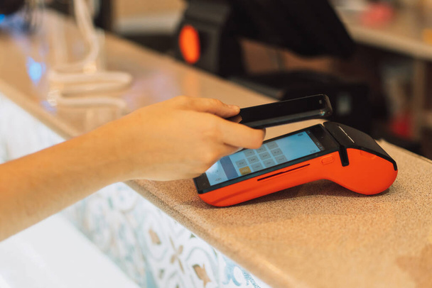 Contactless payment from the phone through the pos terminal. - Photo, Image