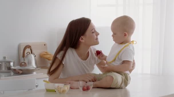 Adorable Infant Baby Feeding Mom With Strawberry While Having Snacks In Kitchen - Footage, Video