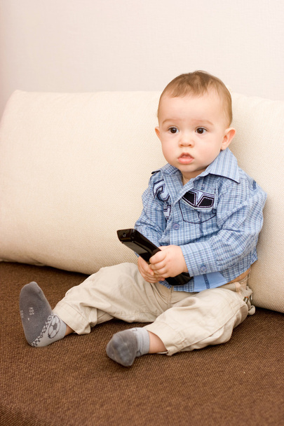 Cute caucasian boy with tv console - Фото, изображение