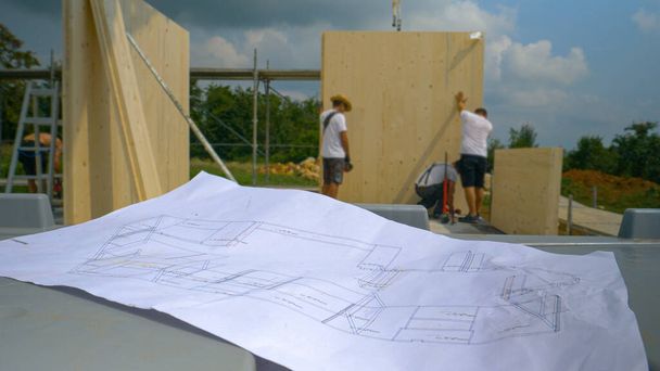 CLOSE UP: Floor plans lie on the workbench at a construction site in countryside - Photo, Image