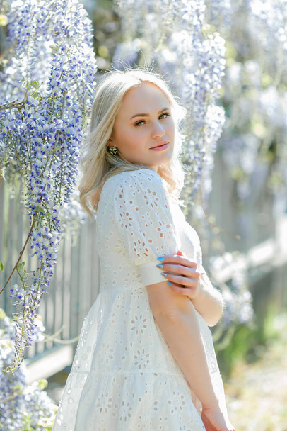 Portrait of a young beautiful woman in a blooming garden. Spring. - Foto, Imagen