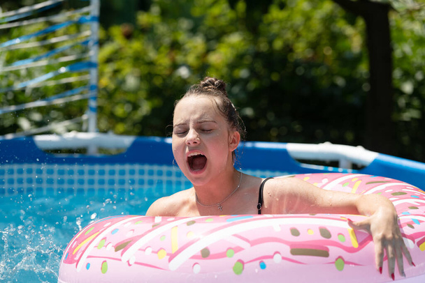 All I want to do is swim. Unhappy girl child in swim ring. Swimming pool activities - Photo, Image