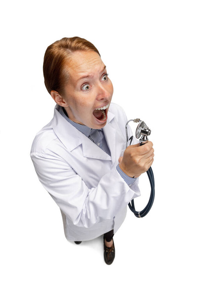Portrait of female doctor, therapeutic or medical advisor with stethoscope at work. Funny meme emotions. Concept of healthcare, care medicine and humor - Fotografie, Obrázek
