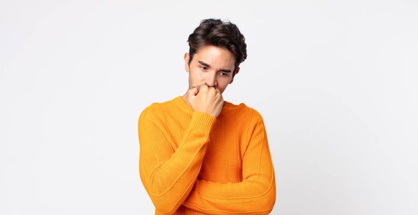 hispanic handsome man feeling serious, thoughtful and concerned, staring sideways with hand pressed against chin - Photo, Image