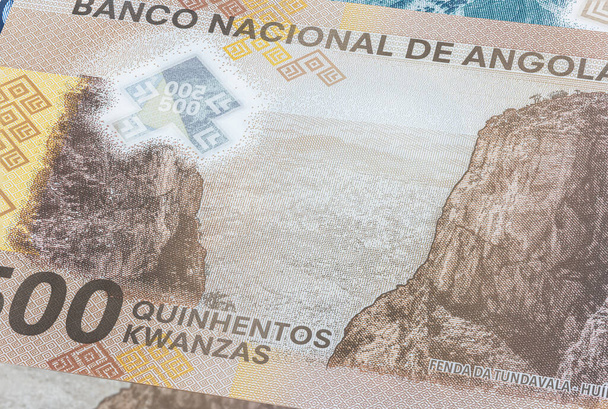 Close up to Kwanza of the Republic of Angola. Polymer banknotes of the African country. Detailed capture of the front art design. Detailed money background wallpaper. Currency bank note Kwanzas - Photo, Image