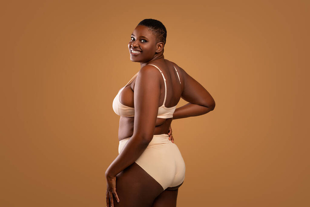 Портрет кривой улыбающейся афроамериканки в нижнем белье - Фото, изображение