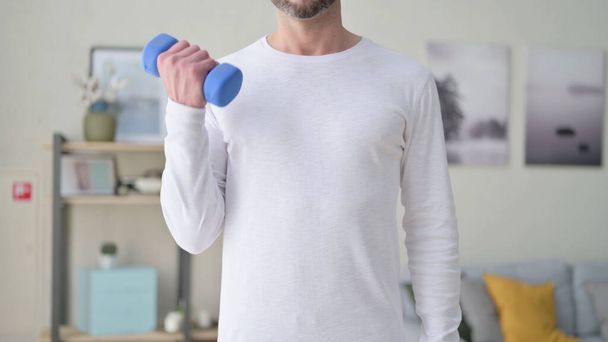 Close up of Young Man Exercising with Dumbbells  - Foto, Bild