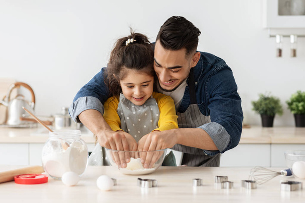 Loving Arab Dad Teaching Cute Little Daughter How To Knead Dough - Photo, Image