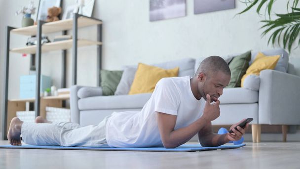 African Man using Smartphone after Exercise - Photo, image