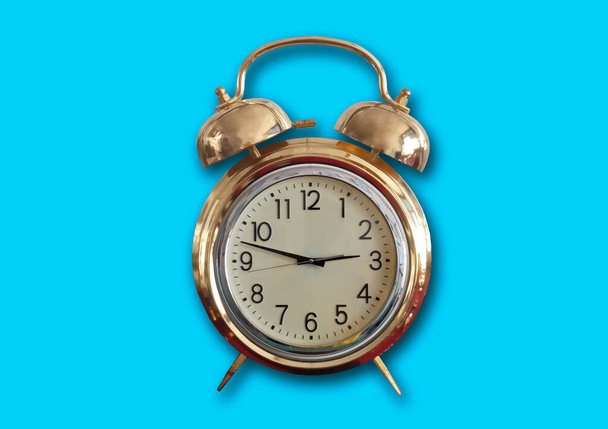 Single analog alarm clock isolated on light cyan for background or stock photo, clock telling time, object, product  - Photo, Image