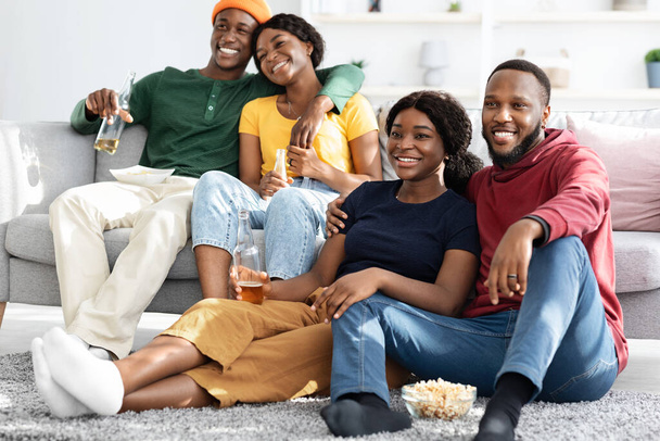 Two loving black couples watching romantic movie at home - Фото, зображення