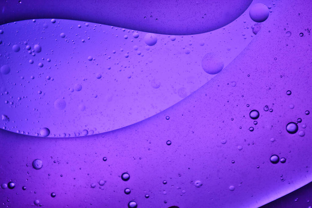 close-up view of a purple liquid background of moving bubbles - Photo, Image