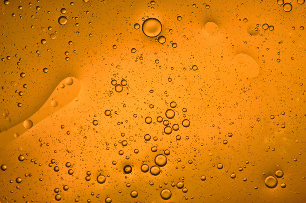 close-up view of a orange liquid background of moving bubbles - Photo, Image