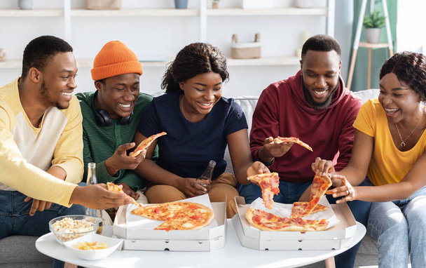 Стильная африканская молодежь, наслаждающаяся вкусной пиццей - Фото, изображение