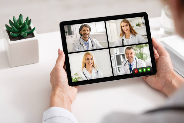 Female Doctor Having Virtual Meeting With Group Of Colleagues Indoor - Photo, Image