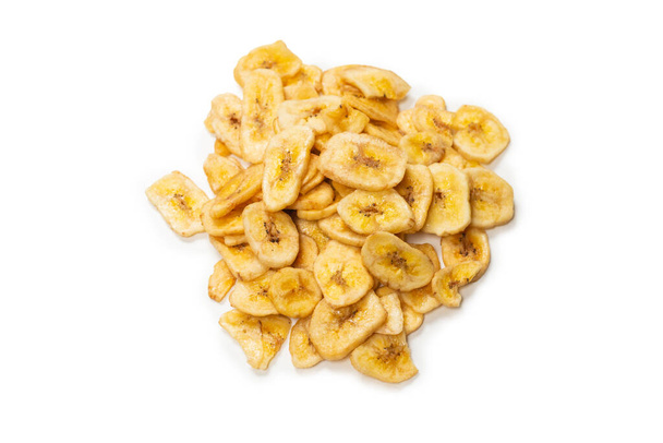 Banana chips isolated on a white background. Dehydrated banana slices.  - Foto, Bild