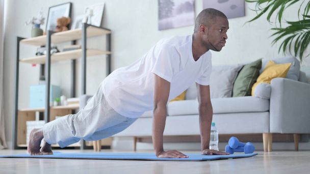 African Man doing Pushups at Home - 写真・画像