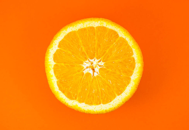 Close up photo of orange texture on the orange background. Fruit cut in half, inside, macro view. Minimalism, original and creative image. Beautiful natural wallpaper. - Фото, зображення