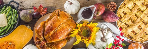 Happy Thanksgiving concept. Thanksgiving day celebration dinner setting with traditional meal and food - green beans, mashed potatoes, cranberry sauce, pumpkin soup, autumn fruits, vegetables - Photo, Image