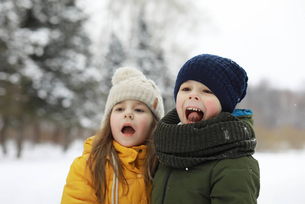 Familia feliz jugando y riendo en invierno al aire libre en la nieve. Parque de la ciudad día de invierno. - Foto, Imagen