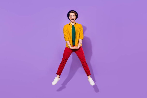 Full body photo of young guy happy positive smile have fun jump up isolated over purple color background - Photo, image