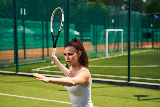 Serious focused woman playing a sports game - Foto, imagen