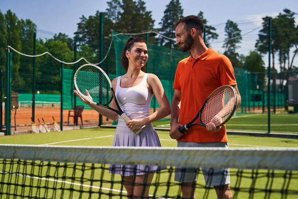 Two sportspeople with rackets on the court - Photo, Image
