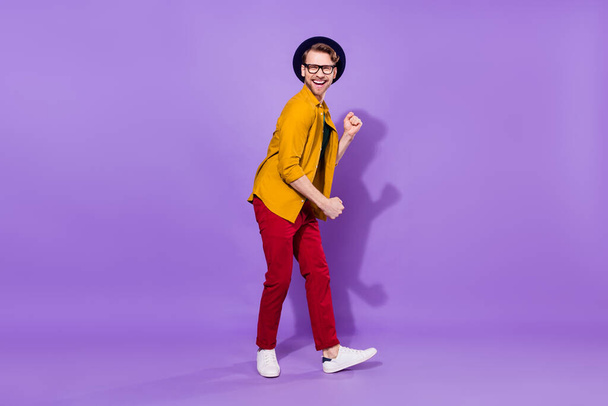 Full size profile side photo of young man happy positive smile have fun dance isolated over purple color background - Photo, image