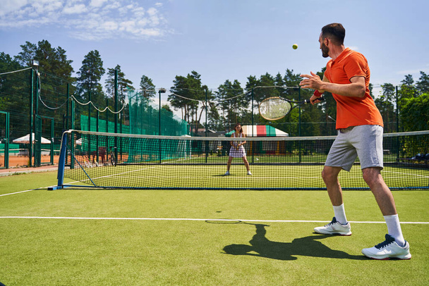 Man and woman playing tennis on the court - Photo, Image