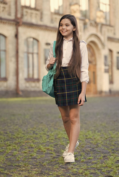 Little girl formal style uniform and backpack in school yard, public school concept - Fotografie, Obrázek