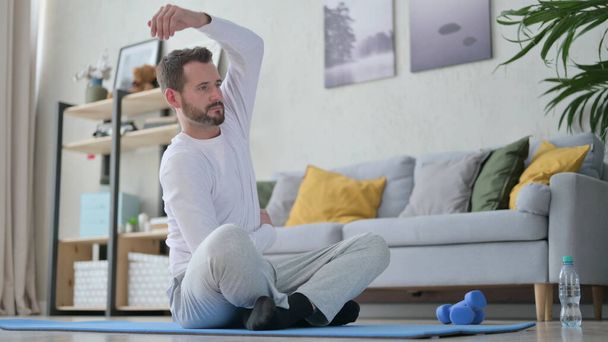 Mature Adult Man Stretching Body at Home - Photo, image