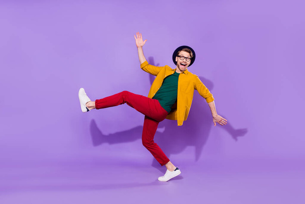 Full length body size view of attractive cheerful guy having fun fooling isolated over bright violet purple color background - Photo, image