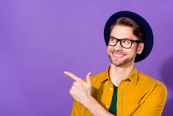 Portrait of attractive cheerful guy demonstrating copy space ad advert isolated over bright violet purple color background - Fotografie, Obrázek