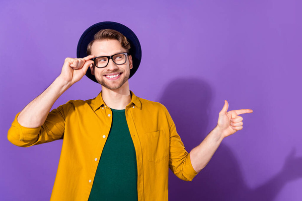 Photo of cheerful charming dream young man point finger look empty space isolated on purple color background - Foto, imagen