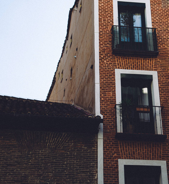 An old red brick building with balconies in Madrid, Spain - Фото, зображення