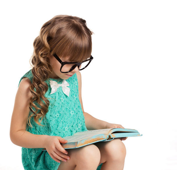 little girl reading book - Фото, изображение