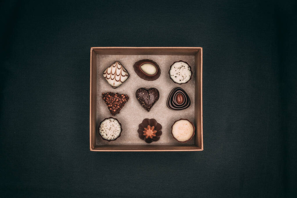 A closeup of a box with chocolate on the black background. Top view. - Photo, image