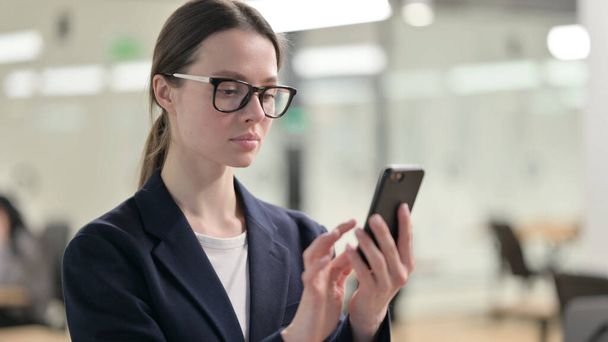 Portrait of Young Businesswoman using Smartphone - Photo, image