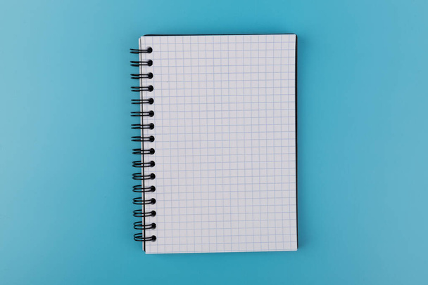 Opened notebook isolated on a blue. Clipping path included. - Photo, Image