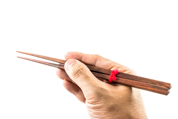 Male hand holding chopsticks isolated on white background - Photo, Image