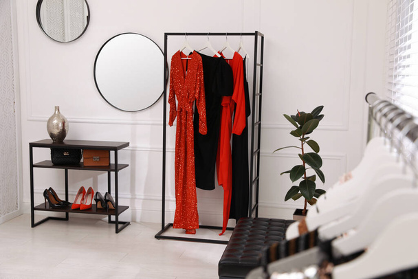 Collection of trendy women's garments in clothing rental salon - 写真・画像