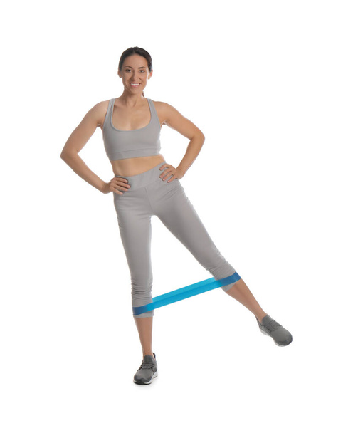 Woman doing sportive exercise with fitness elastic band on white background - Zdjęcie, obraz