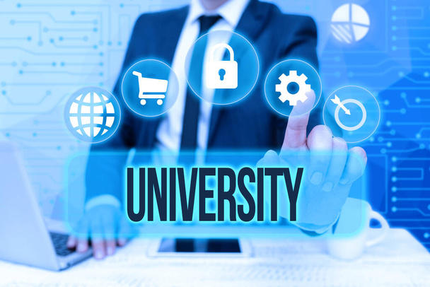 Hand writing sign University. Business concept an educational institution designed to teach and investigate Bussiness Man Sitting Desk Laptop And Phone Pointing Futuristic Technology. - Photo, Image
