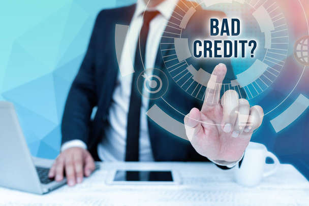 Handwriting text Bad Credit Question. Business concept a bad credit score due to nonpayment of loans Bussiness Man Sitting Desk Laptop And Phone Pointing Futuristic Technology. - Photo, Image