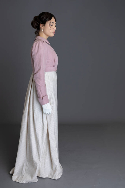 A Regency woman wearing a printed cotton dress and a pink linen spencer - Foto, Imagen