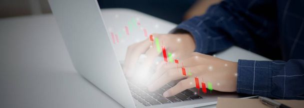 Hands of businessman using laptop computer having graph of investment with risk stock and funds virtual on desk, marketing for strategy and planning for success, business futuristic concepts. - Photo, Image