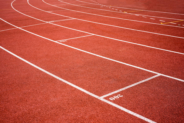 red running track on athletic stadium background texture  - Photo, Image
